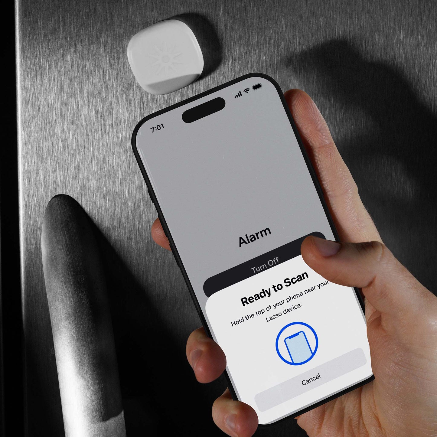 Scanning the Lasso Alarm Clock device attached to a refrigerator
