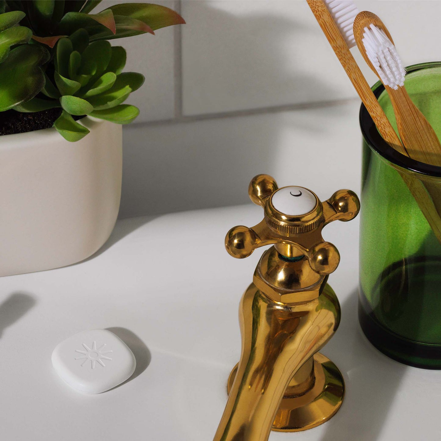 Lasso Alarm Clock device sitting next to a toothbrush