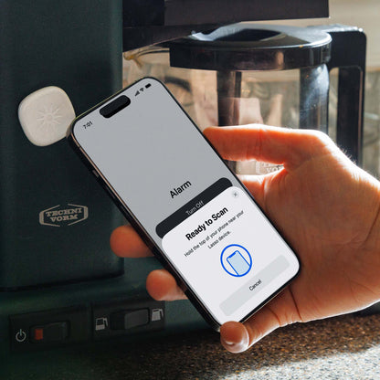 Scanning the Lasso Alarm Clock device next to a coffee pot in the kitchen